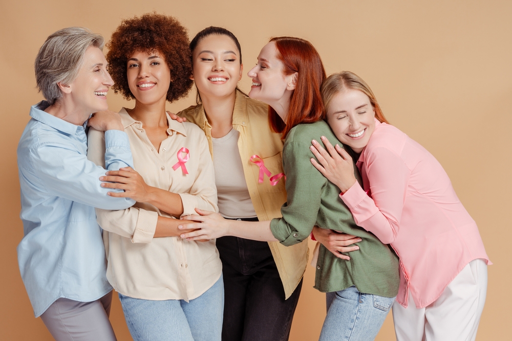 GroupOfSmilingMultiethnicWomenWearingBreastCancerPinkRibbon Group Of Smiling Multiethnic Women Wearing Breast Cancer Pink Ribbon