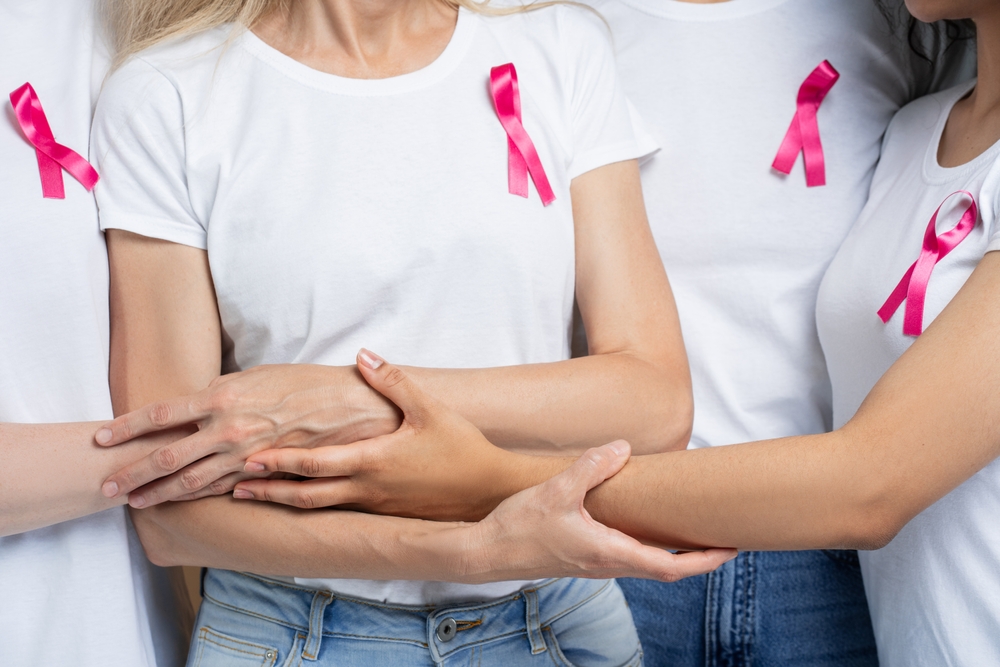 Women In Pink Ribbons Unite Holding Hands For Breast Cancer