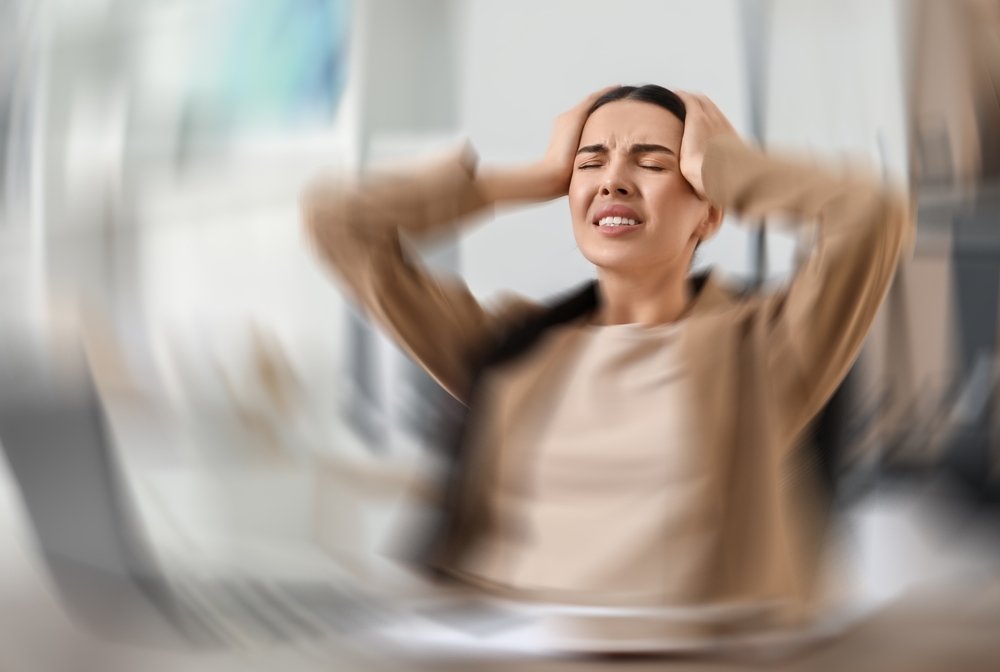 Woman Suffering From Headache Indoors Motion Blur Effect