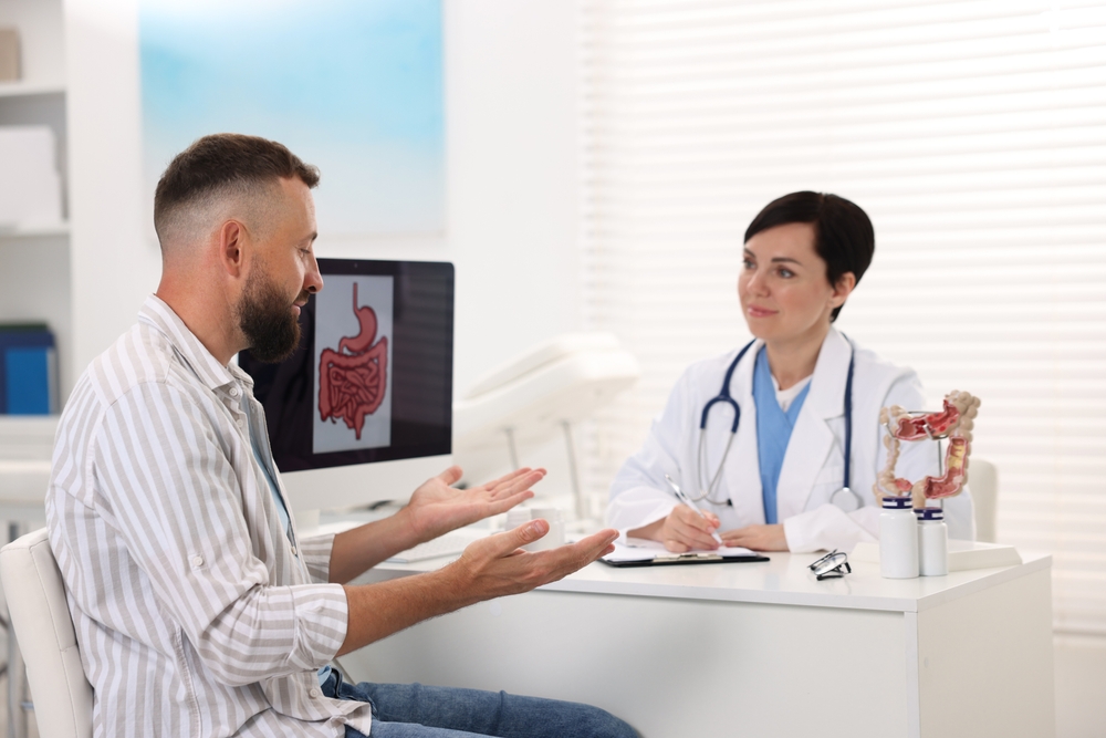 ManHavingAppointmentWithGastroenterologistInClinic Man Having Appointment With Gastroenterologist In Clinic