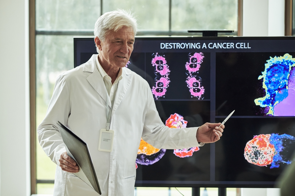 Senior Caucasian Male Professor Presenting Scientific Research Holding Digital Tablet