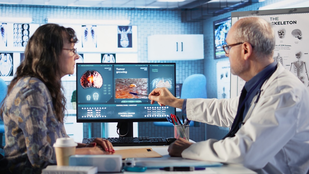 Male Oncology Expert Reviews Radiography Results With A Patient Discussing