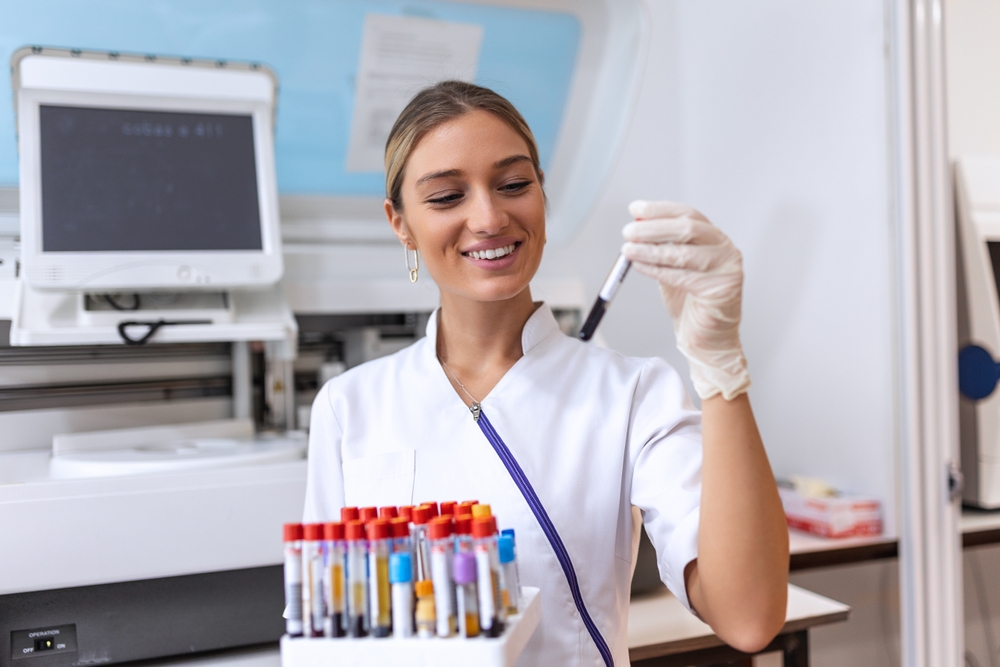 Technician Holding Blood Tube Test In The Research Laboratory. Coronavirus