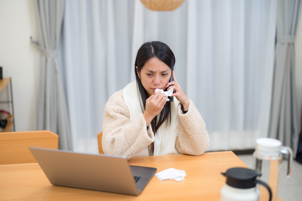 Woman With Flu Symptoms Talking Phone Working Laptop