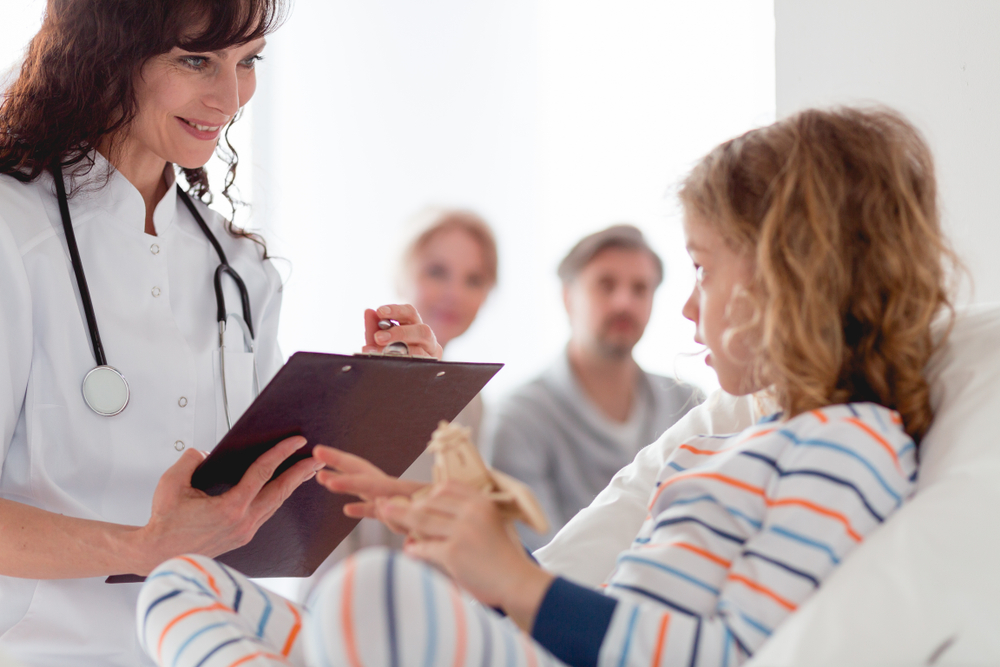 Little Girl In A Hospital Telling Her Medical Story To