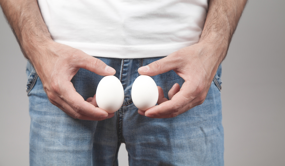 Caucasian Man Showing Two Eggs.