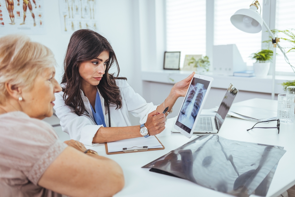 Professional Doctor Explaining Lungs X-ray Film About Coronavirus Covid-19 Infected