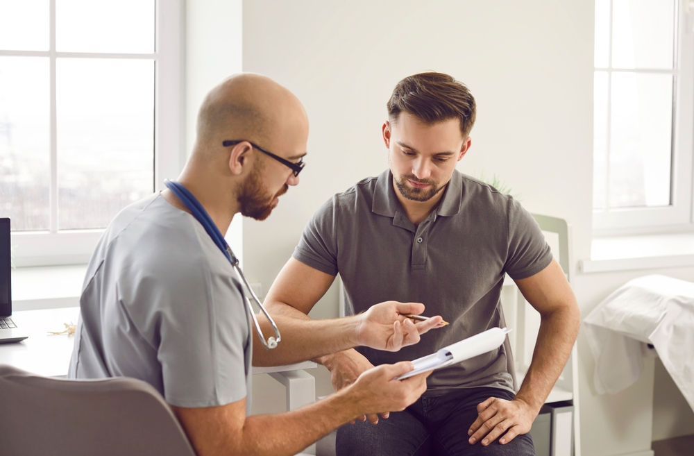 Doctor Talks To His Patient After A Medical Examination At