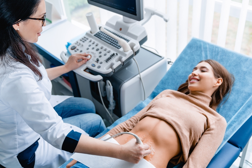 Doctor Using Ultrasound And Screening Woman's Stomach For Gastritis Prevention
