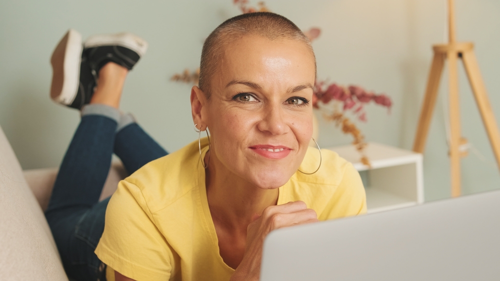 Smiling Woman Dressed In Yellow T-shirt And Jeans Lying