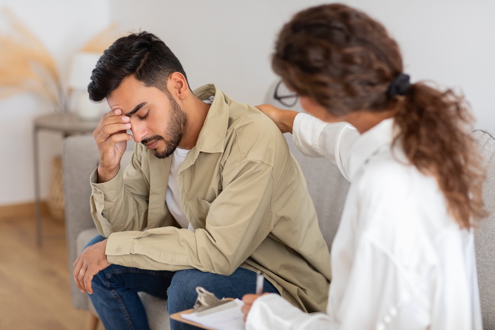 An Adult Man Appears Troubled Requiring Support As The Woman