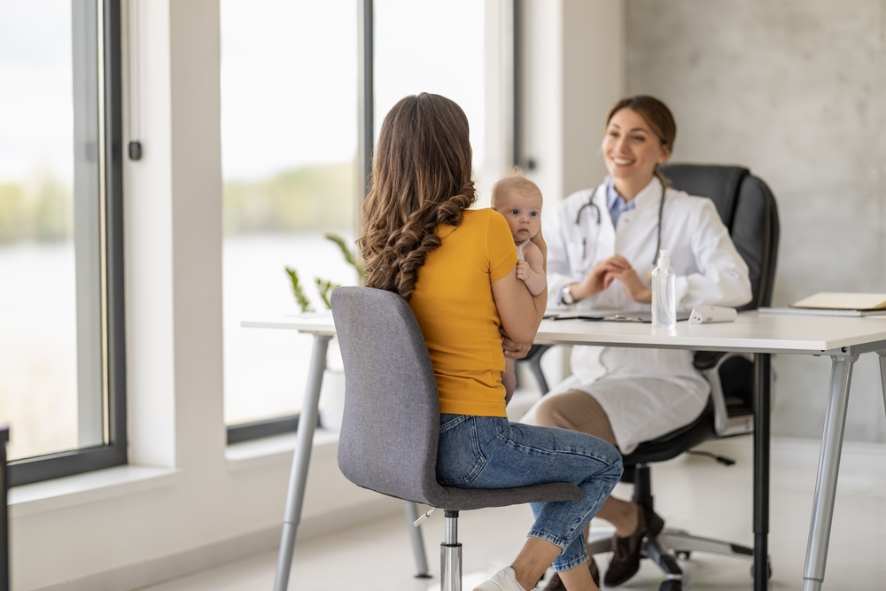 Young Mother Attentively Accompanies Her Little Baby For A Regular