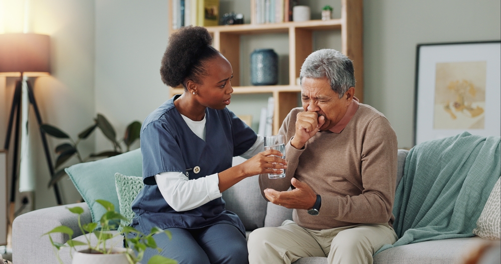 Elderly Man And Coughing With Nurse For Healthcare With Water