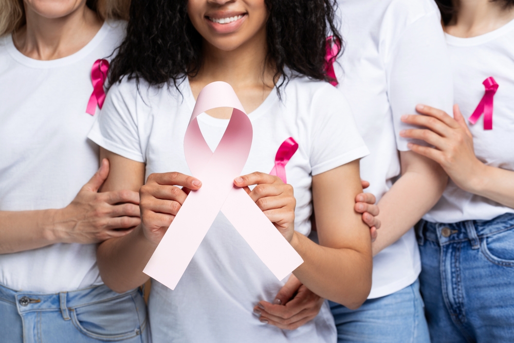 Diverse Women Stand Together Embracing For Breast Cancer Awareness Radiating