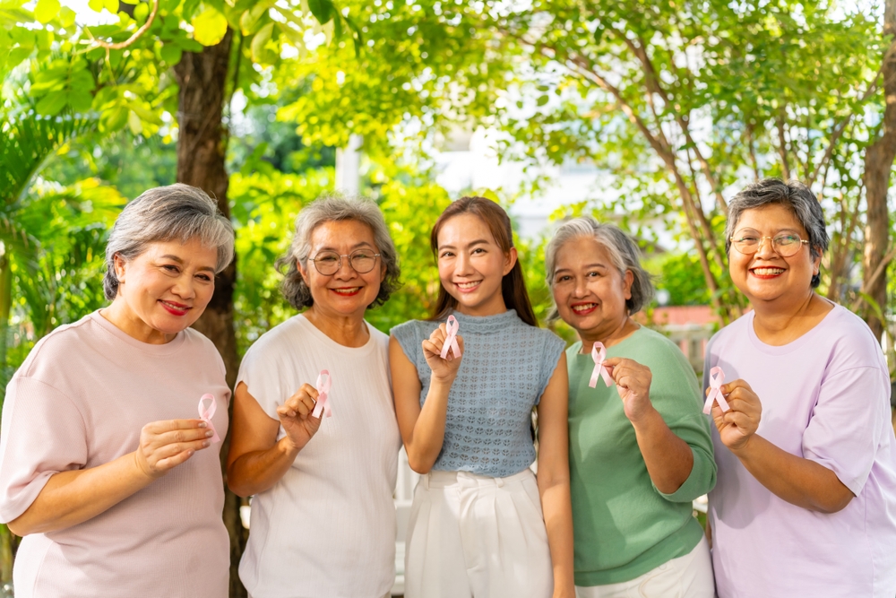 Breast Cancer Awareness Charity Concept. Group Of Smiling Asian Senior