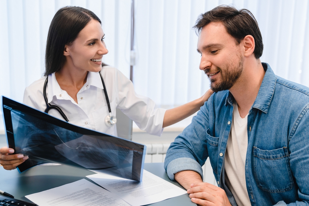 Pulmonology Concept. Female Doctor Radiologist Explaining Examining At Lungs Radiograph