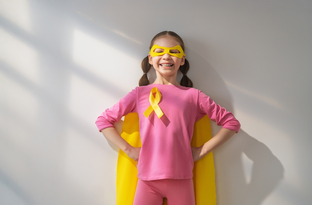 World Childhood Cancer Day. Girl In Superhero Costume With Golden