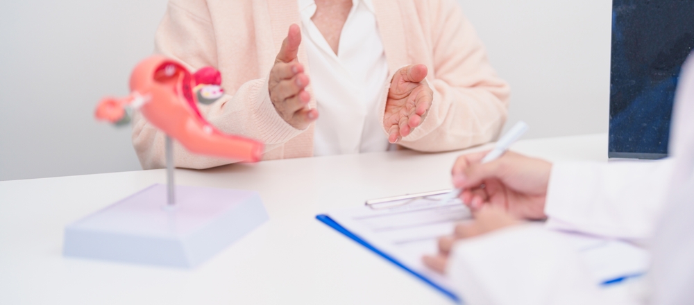 Elderly,Woman,Patient,Consulting,Doctor,With,Anatomy,Uterus,And,Ovaries. Elderly Woman Patient Consulting Doctor With Anatomy Uterus And Ovaries.