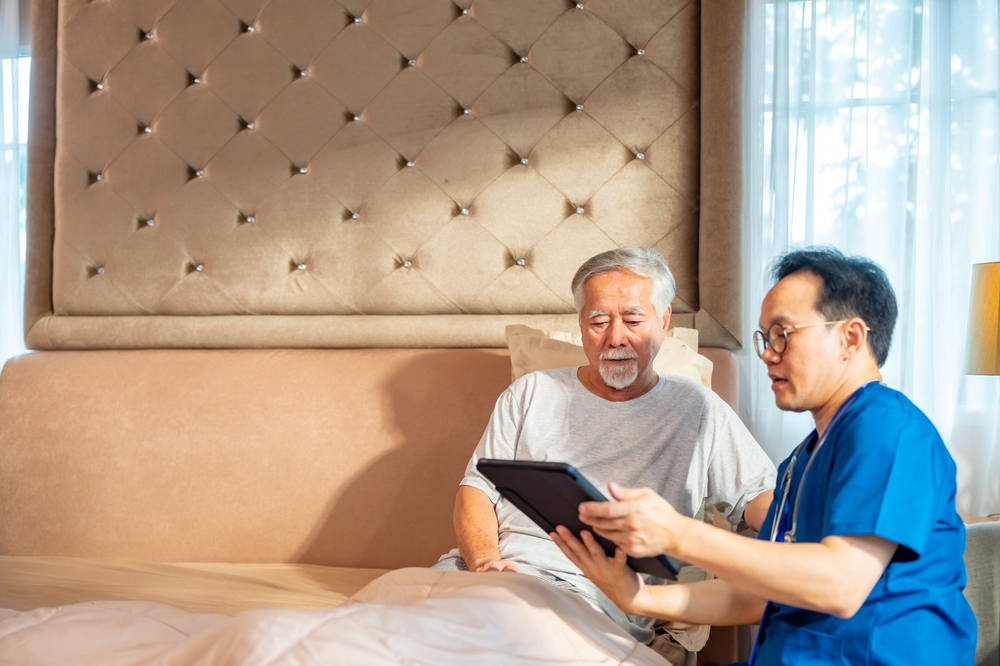 Happy Asian Man Doctor Examine And Consult Senior Male Patient