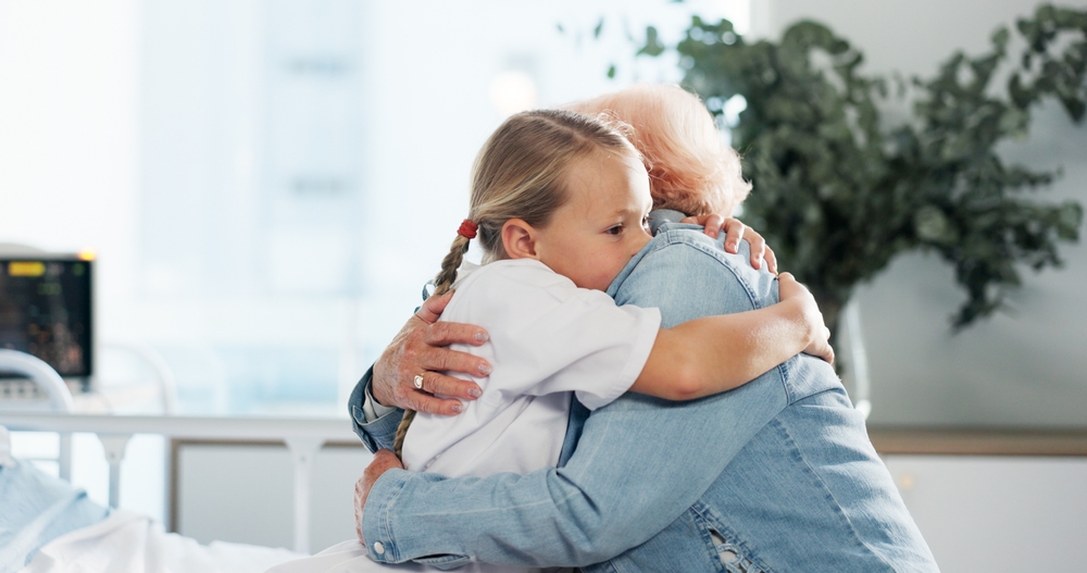 Hug Support And Grandmother With Child In Hospital For Healthcare