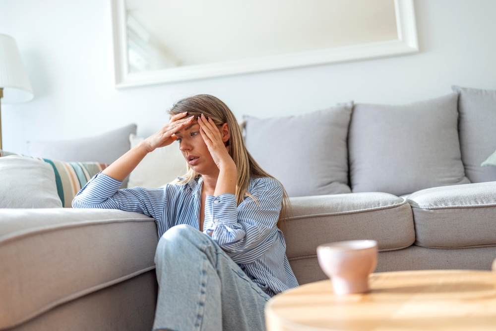 A,Young,Woman,Sits,On,The,Floor,In,A,Comfortable A Young Woman Sits The Floor In A Comfortable