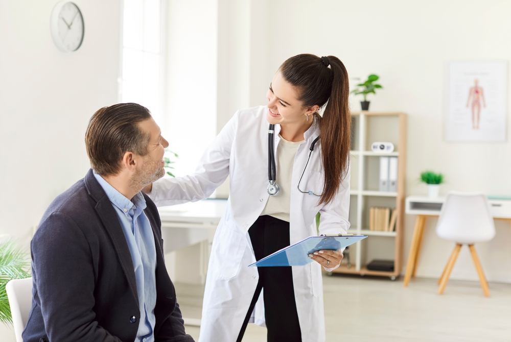 Woman Doctor Or Nurse Offers Support To A Patient During