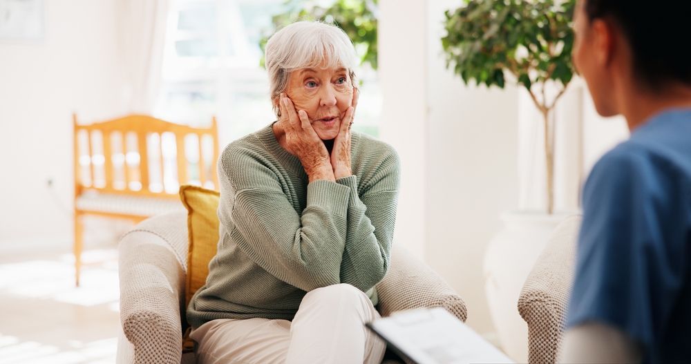 Stress Old Woman And Nurse With Checkup In Home For