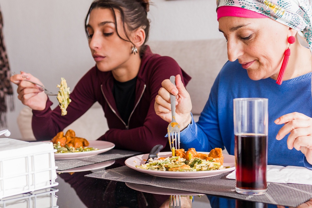 Mother And Daughter Eating Lunch During Cancer Recovery