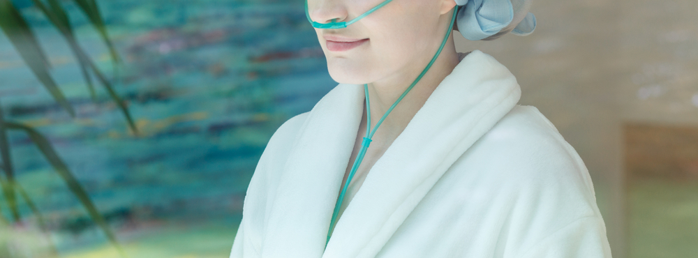 Woman With Cancer Wearing Bathrobe At Home