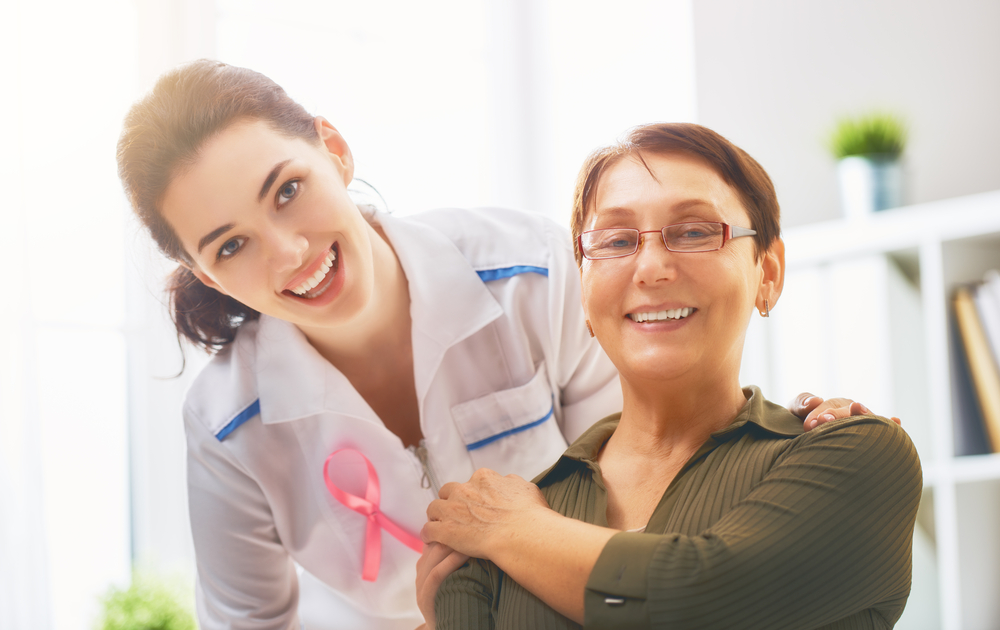 Pink Ribbon For Breast Cancer Awareness. Female Patient Listening To