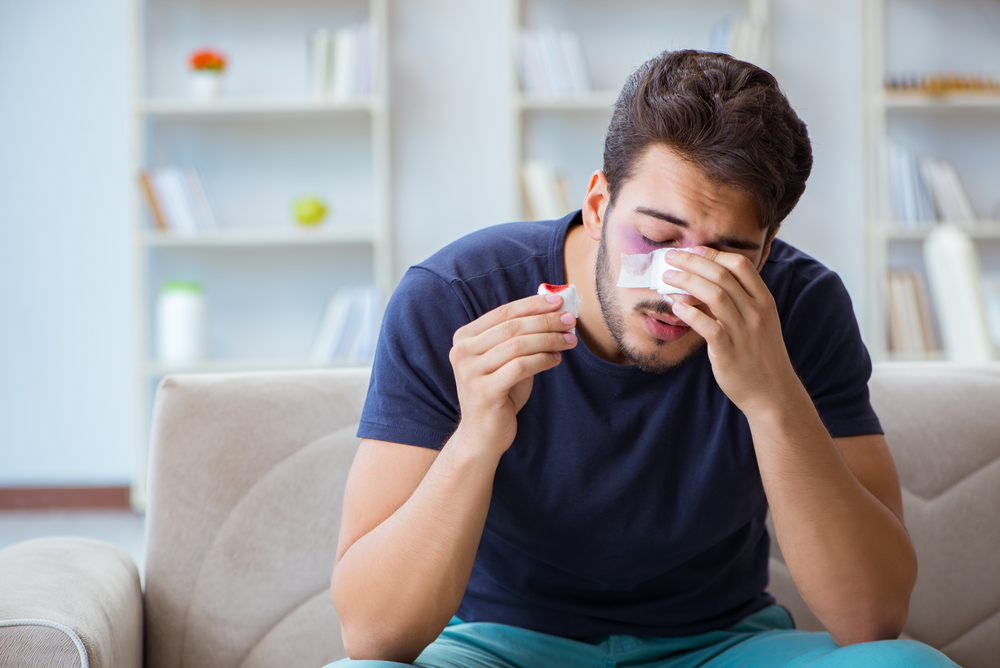 Young Man Recovering Healing At Home After Plastic Surgery Nose