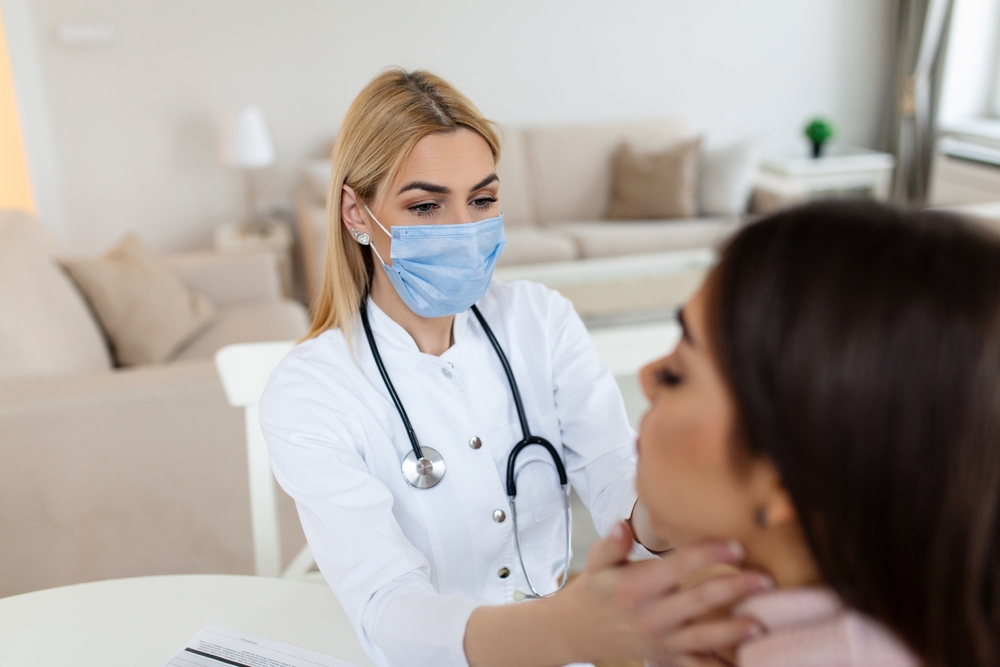 Young,Woman,Sitting,While,The,Doctor,Examining,Her,Throat.,Physician Young Woman Sitting While The Doctor Examining Her Throat. Physician