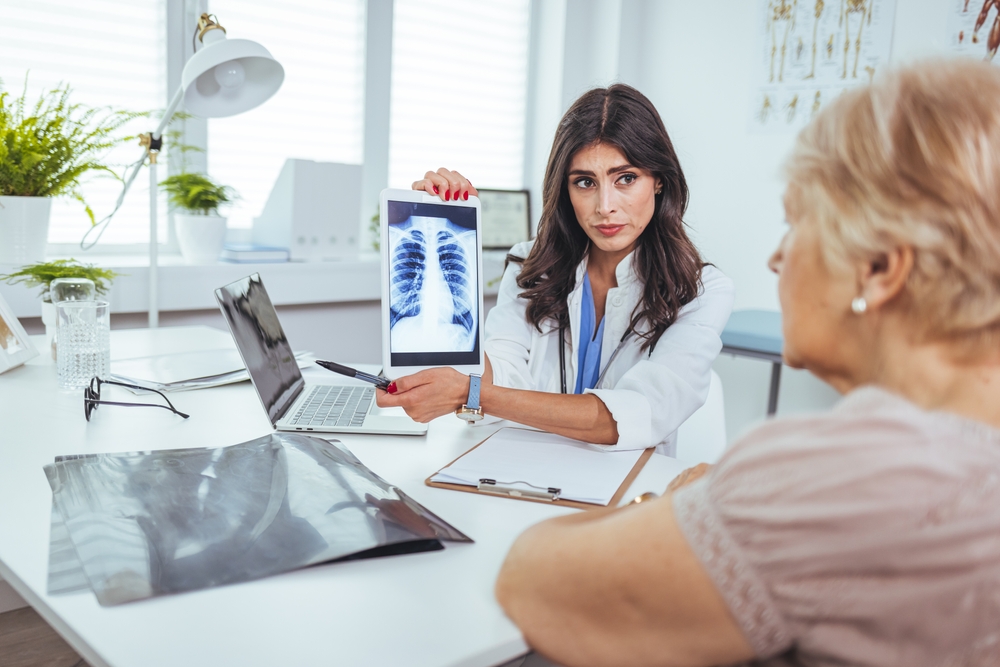 Doctor With Radiological Chest X-ray Film For Medical Diagnosis